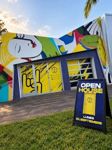 Fachada artística de La Connector House, con mural colorido y entrada amarilla